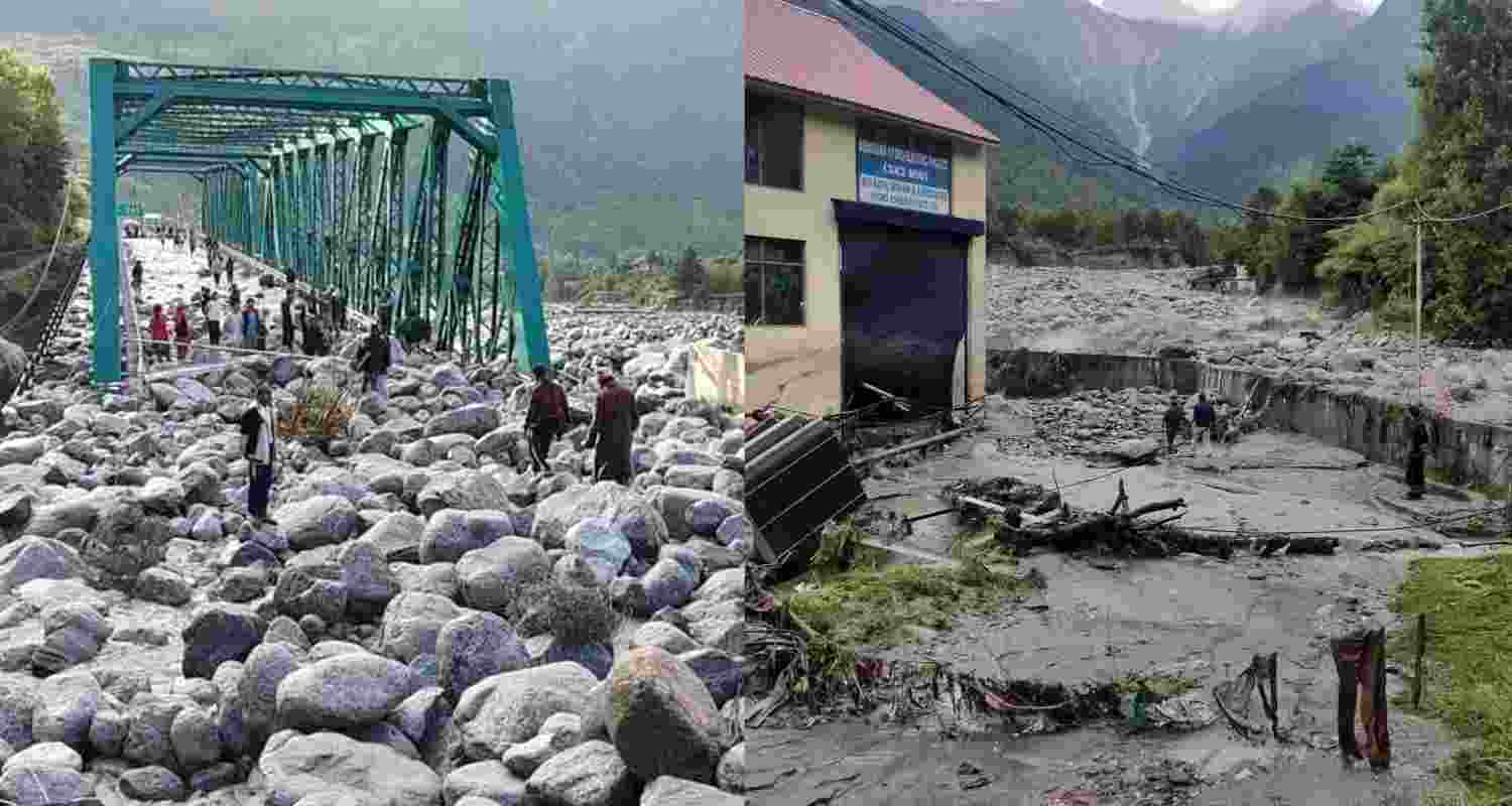  People stand near debris after flash floods triggered by cloud burst, near Manali. 