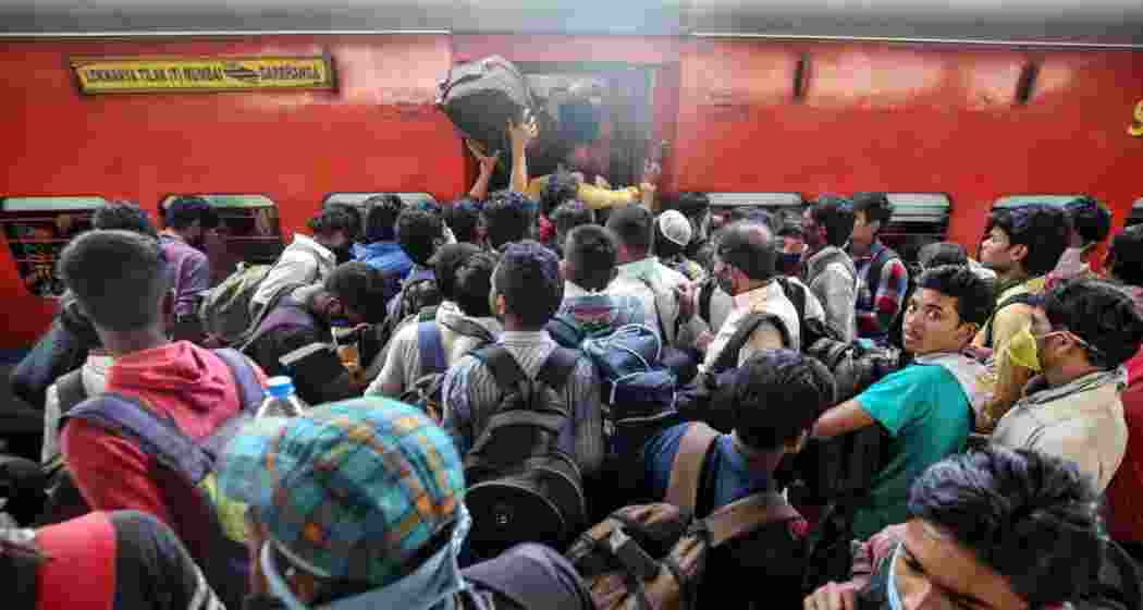 A crowded Indian railway train showcases the bustling demand for affordable travel options as passengers jostle for space.