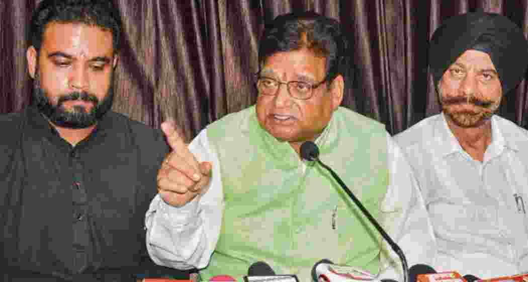 Former BJP leader Chander Mohan Sharma (centre) addresses a press conference in Jammu on Friday. 