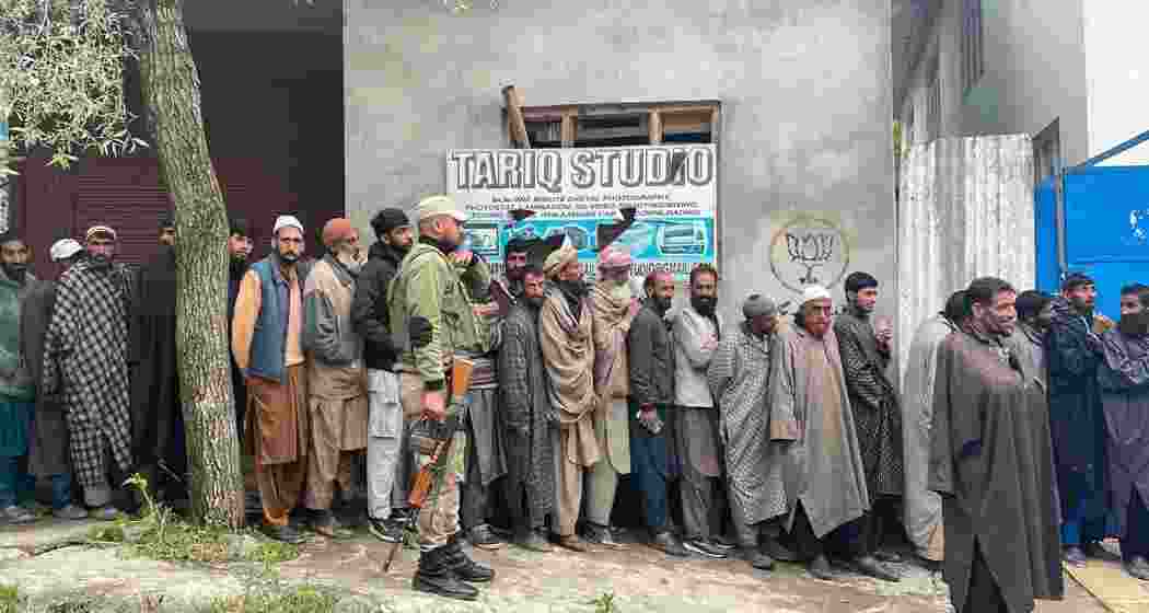 People stand in queues to cast their votes at a polling station during the fourth phase of Lok Sabha elections at Fakeer Gujri on the outskirts of Srinagar on Monday, May 13, 2024.