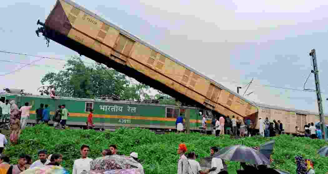 Locals gather after the Kanchanjungha Express was hit by a goods train near New Jalpaiguri station in Darjeeling district of West Bengal on June 17, 2024.