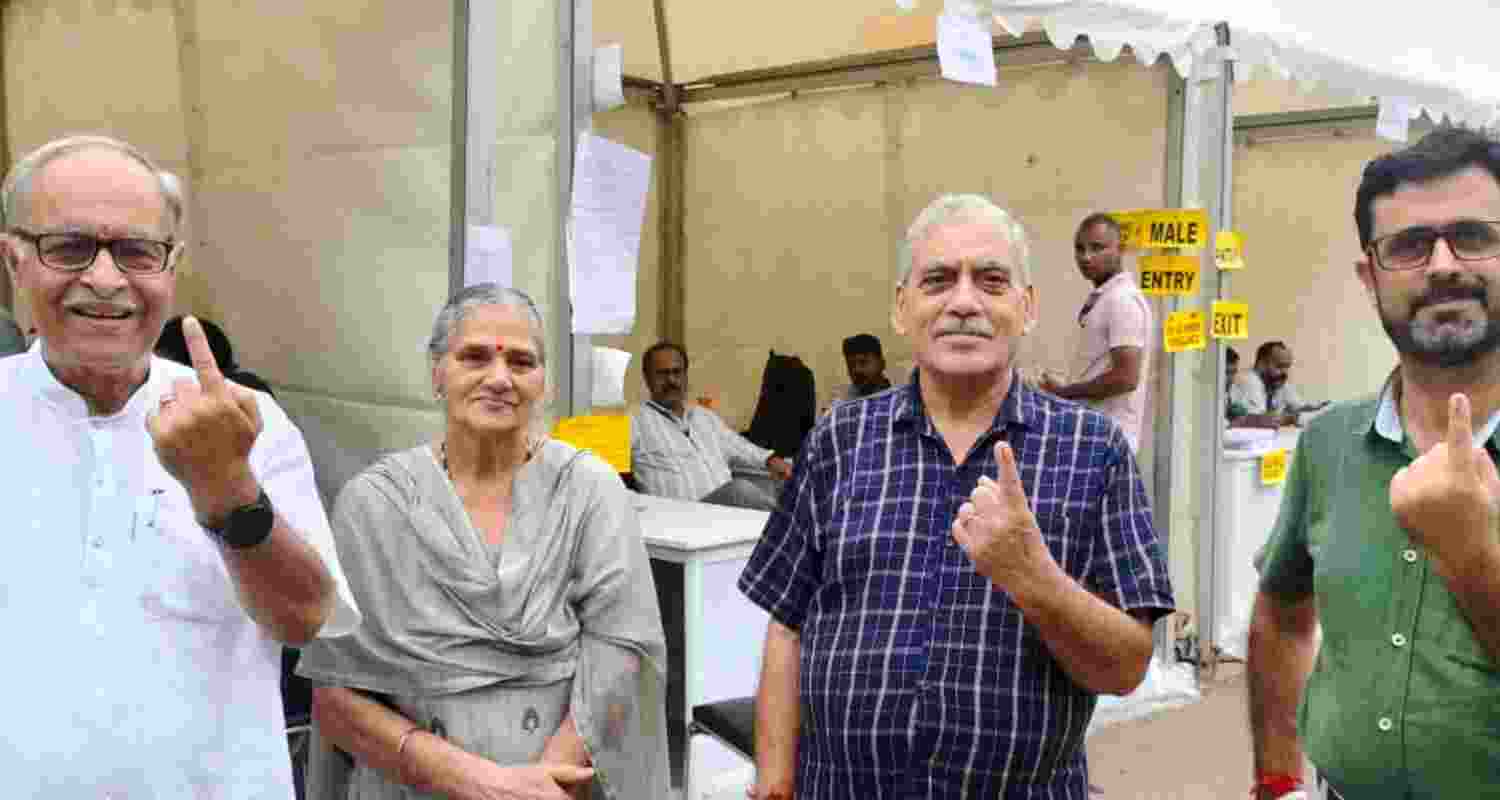 Kashmiri migrants show their fingers marked with indelible ink after casting a vote for the first phase of the Jammu and Kashmir Assembly elections, in New Delhi.