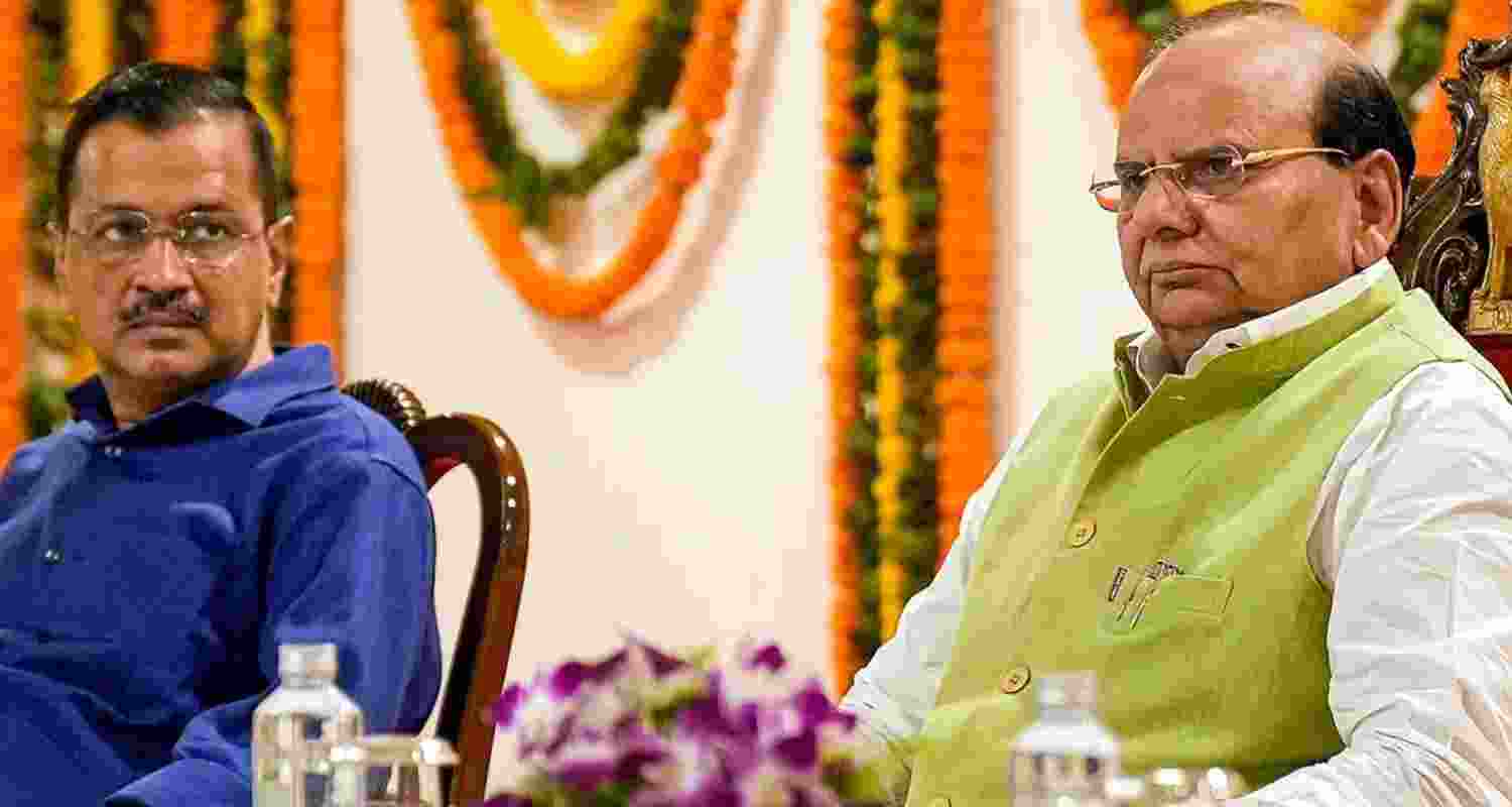 Image of Delhi CM Kejriwal and Lt. Governor V.K. Saxena at an event. 