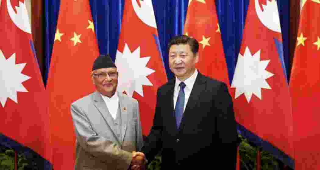 Chinese President Xi Jinping (right) shakes hands with Nepalese Prime Minister Khadga Prasad Oli (left) at the Great Hall of the People in Beijing back in March 21, 2016.