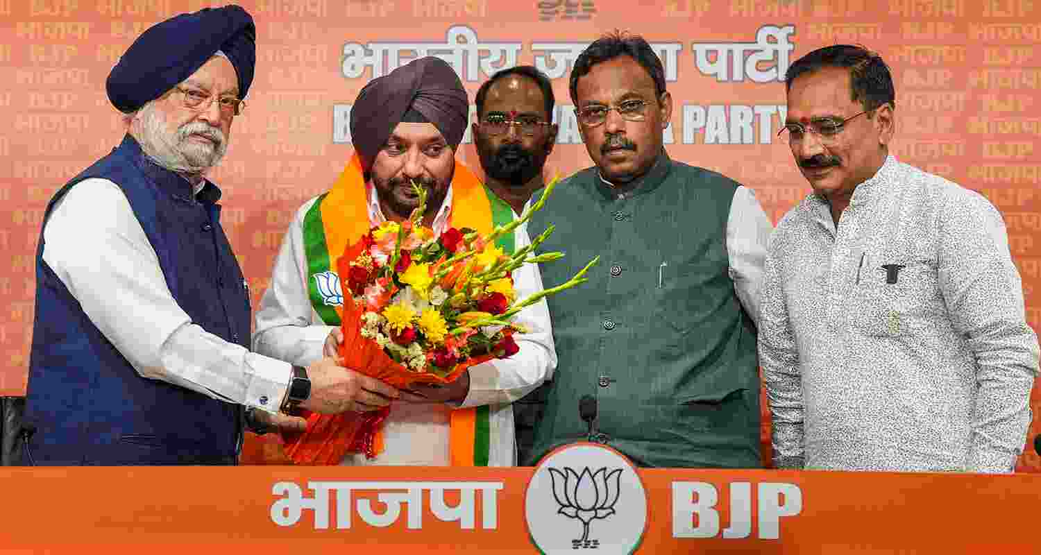 Former Congress leader Arvinder Singh Lovely being felicitated by Union Minister Hardeep Singh Puri, Delhi BJP President Virendra Sachdeva and BJP National General Secretary Vinod Tawde after joining the party, ahead of the third phase of Lok Sabha elections, in New Delhi on Saturday.