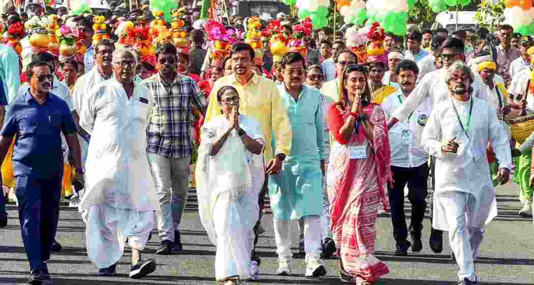 West Bengal Chief Minister and TMC chief Mamata Banerjee with party candidates Saugata Roy and Sayantika Banerjee during a road show for Lok Sabha polls, in Kolkata on Thursday, May 23, 2024.