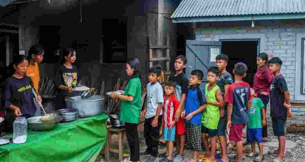 Children line up for food at a relief camp in Manipur.