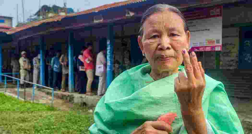 A voter shows her finger marked with indelible ink after casting her vote for Lok Sabha elections, during repolling at 11 polling stations in the Inner Manipur Lok Sabha constituency, Monday.