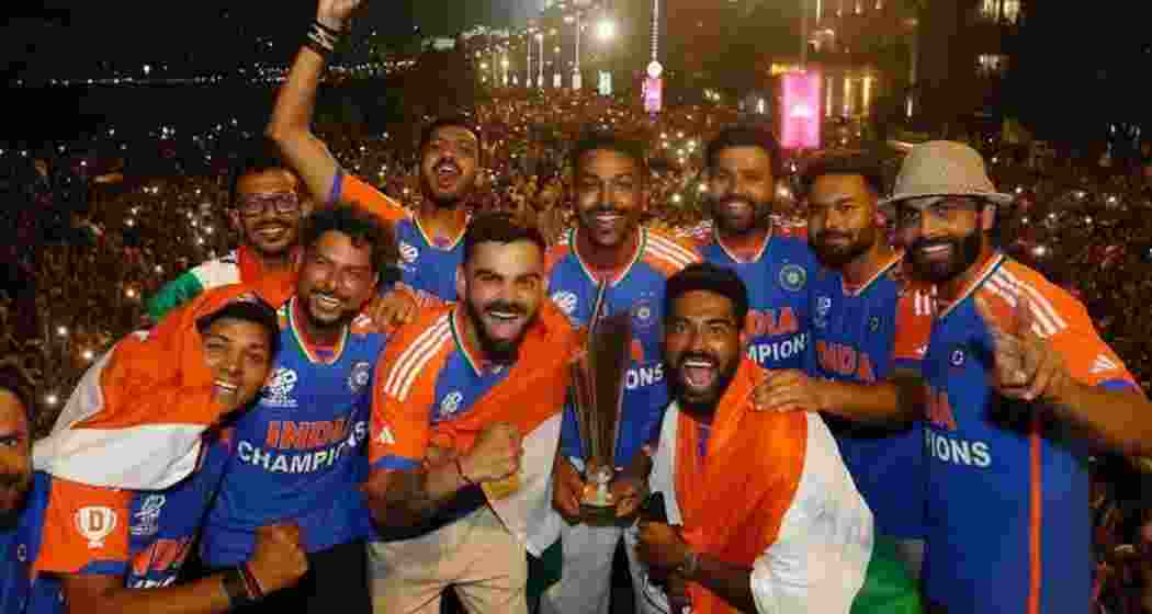 The jubilant Indian cricket team members celebrate during the victory parade in Mumbai on Thursday.