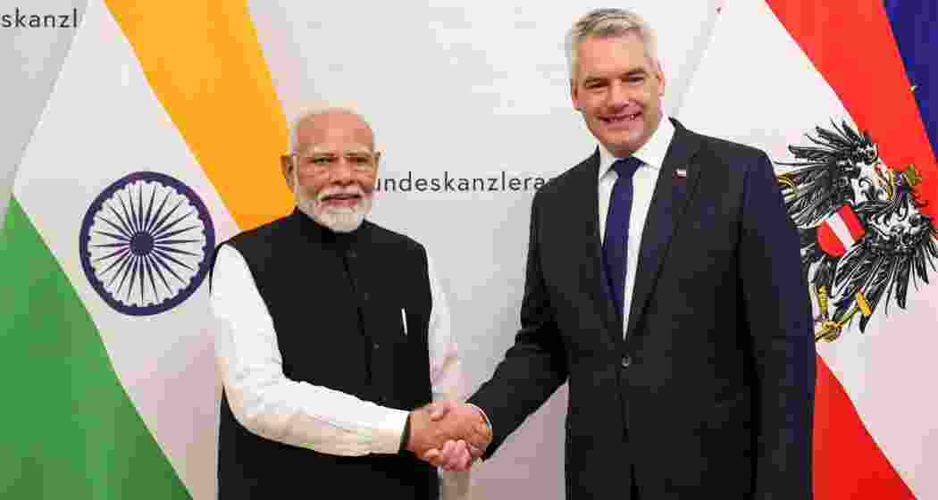 Prime Minister Narendra Modi being greeted by Austrian Chancellor Karl Nehammer during the signing of guest book, in Vienna, Austria, Wednesday, July 10, 2024.