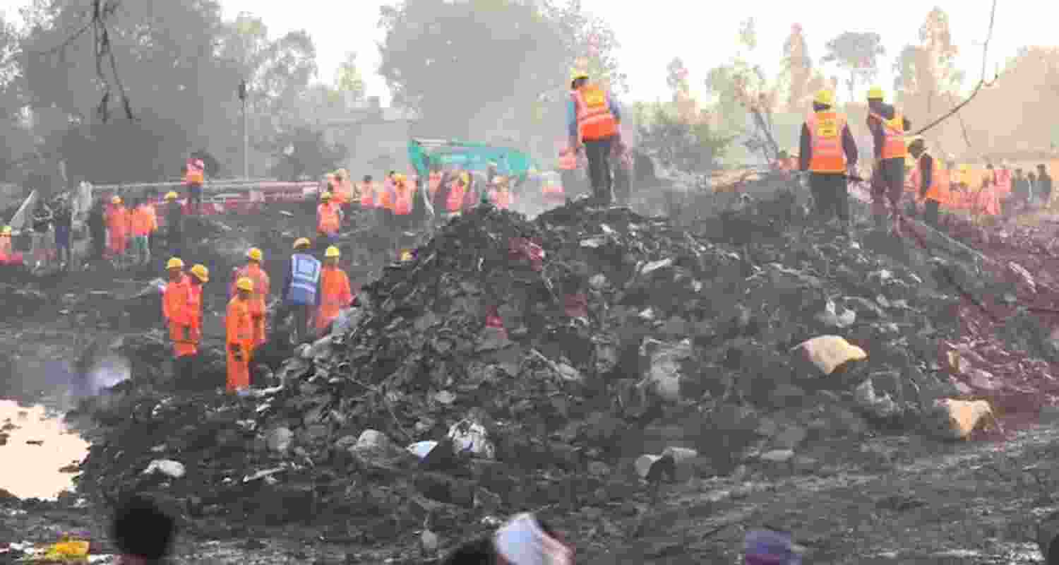 Rescue officials at the site of the firecracker factory where an explosion and subsequent blaze on Tuesday killed at least 11 people and injured nearly 200 others in Harda district on Wednesday. 