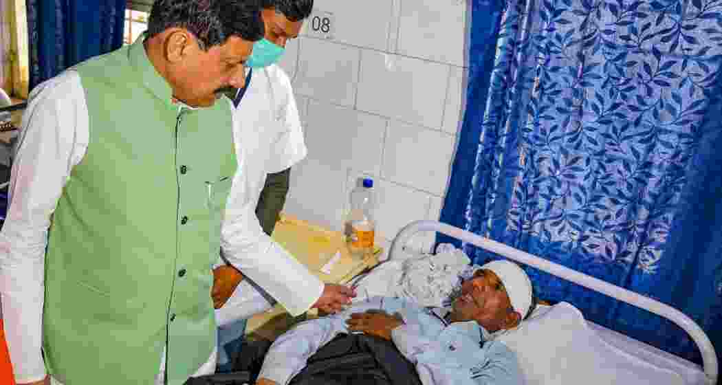 Madhya Pradesh Chief Minister Mohan Yadav meets an injured victim of the firecracker factory blast at a hospital, in Harda on Wednesday.