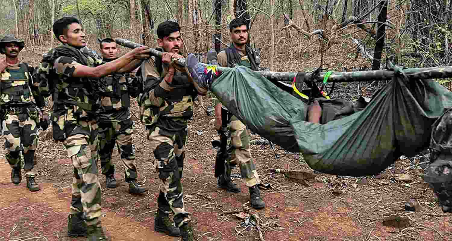 Security personnel carrying dead bodies of slain Naxalites.