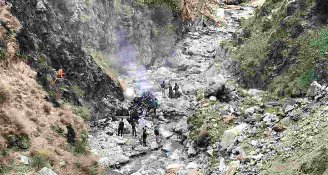 Security officials inspect the wreckage of a vehicle that was carrying Chinese nationals that plunged into a deep ravine off the mountainous Karakoram Highway after a suicide attack near Besham city in the Shangla district of Khyber Pakhtunkhwa province on March 26, 2024.