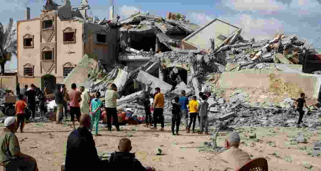 Palestinians look at the site of an Israeli air attack in Rafah in the southern Gaza Strip, May 5, 2024.