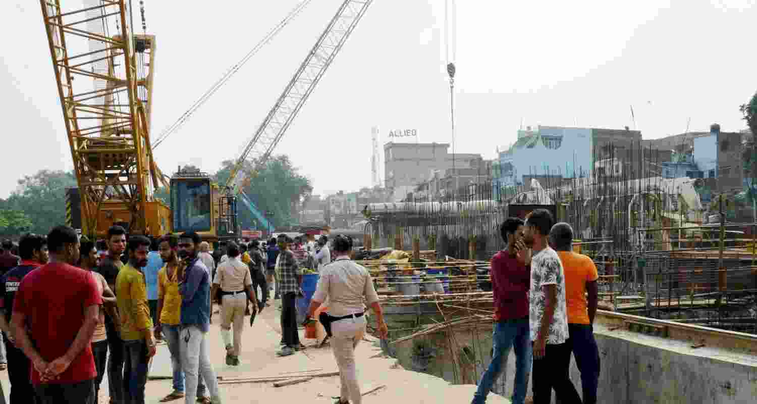 People gather at Patna Metro tunnel construction site where two people died and many were injured.