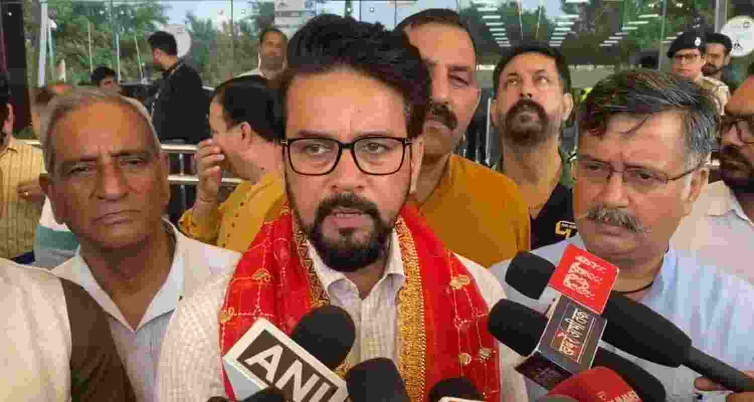 BJP MP Anurag Thakur speaking to reporters.