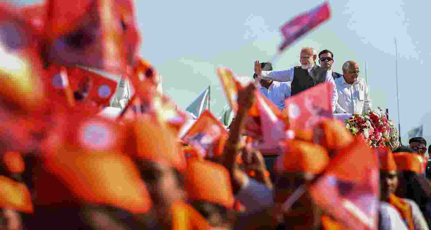 PM Modi waves and addresses to the crowd in navsari, Gujarat.