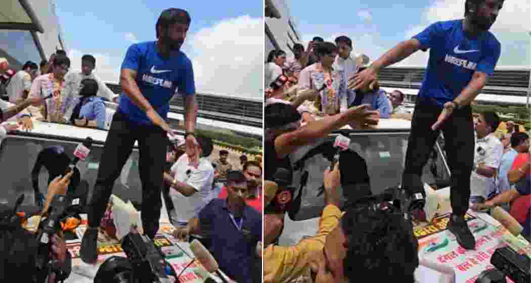 Bajrang Punia stands on a 'Tiranga' poster during Vinesh Phogat's welcome at Delhi Airport, sparking an online controversy.