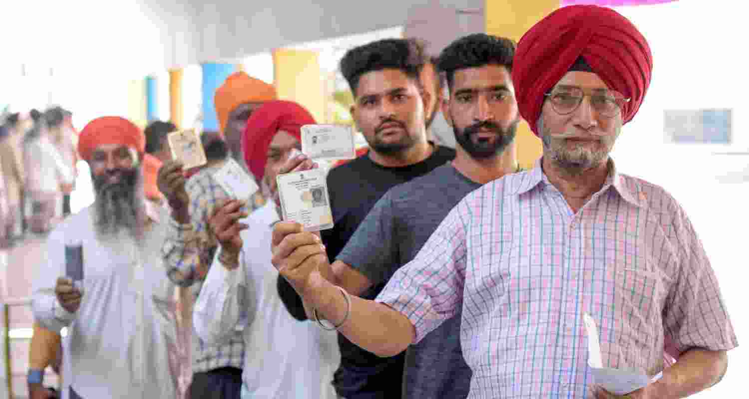 Voters line up at a polling booth in Punjab.