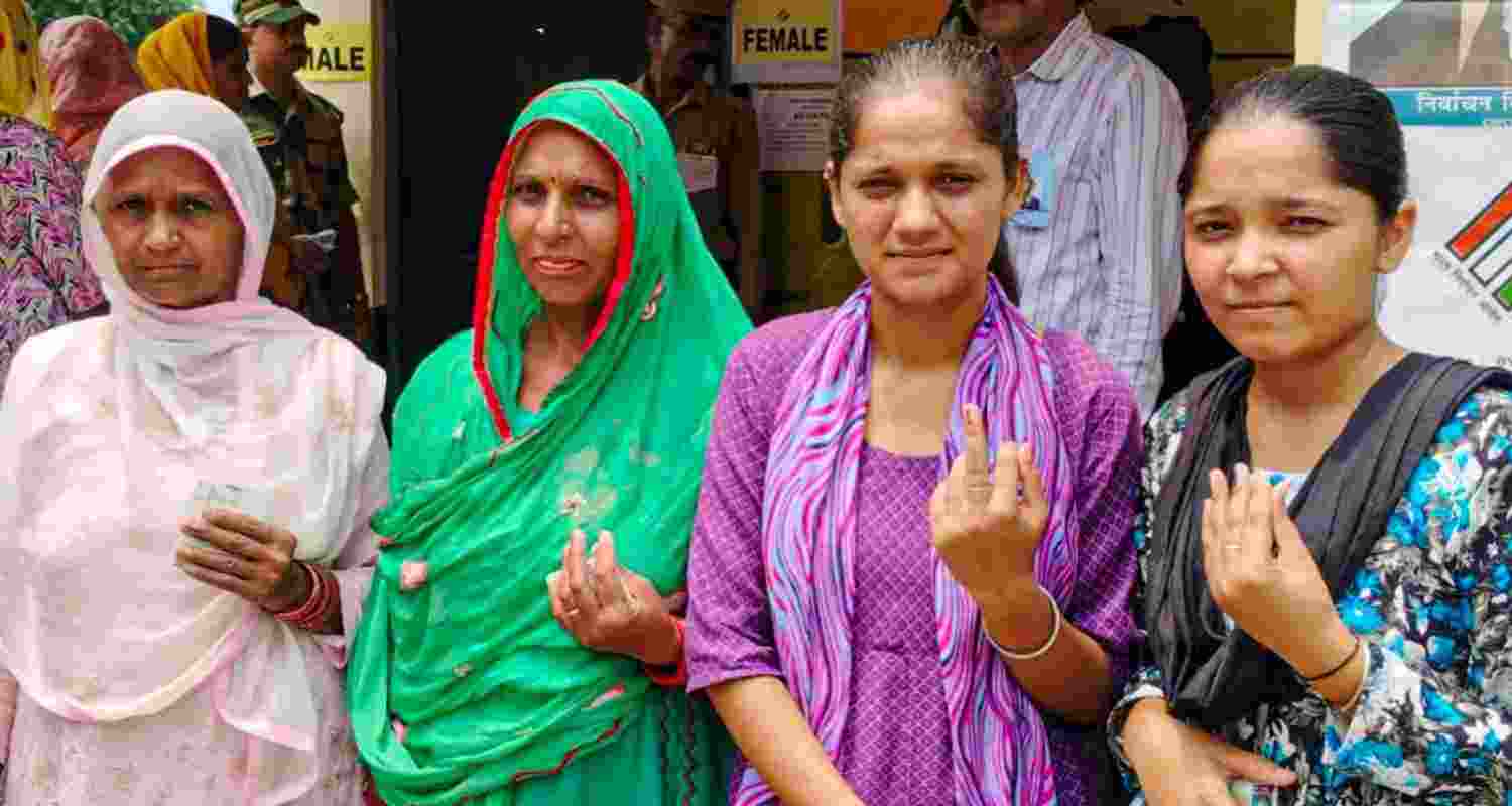 Voters show their fingers marked with indelible ink after casting their votes during the Nalagarh assembly bypoll, in Solan district of Himachal Pradesh, Wednesday. 