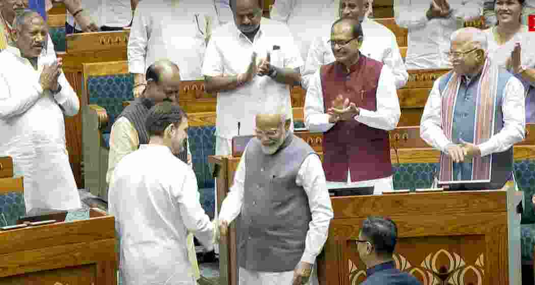 Prime Minister Narendra Modi and Leader of the Opposition Rahul Gandhi escort Om Birla to the chair after the latter was elected as the Speaker of the House during the first session of the 18th Lok Sabha, in New Delhi, Wednesday, June 26, 2024.