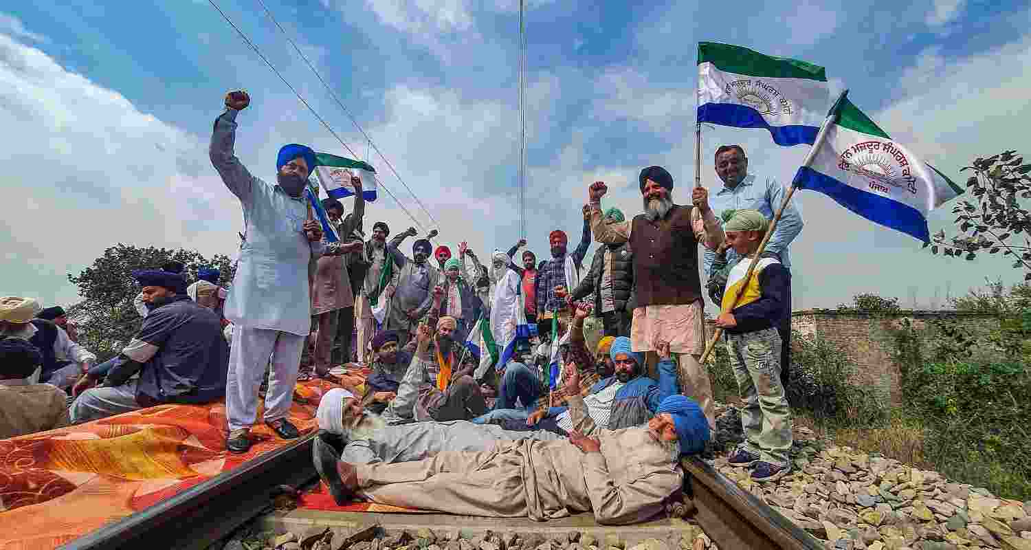 An image of farmers protesting on a railway track,