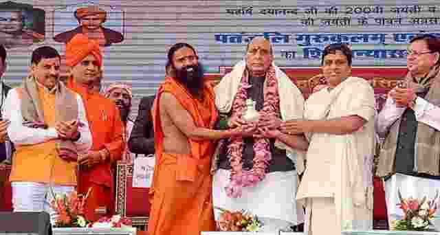 Defence Minister Rajnath Singh on Saturday said Macaulay was sent to India to throttle the country's traditional system of education and enslave Indians mentally colonising their minds  Yoga Guru Ramdev Uttarakhand Chief Minister Pushkar Singh Dhami