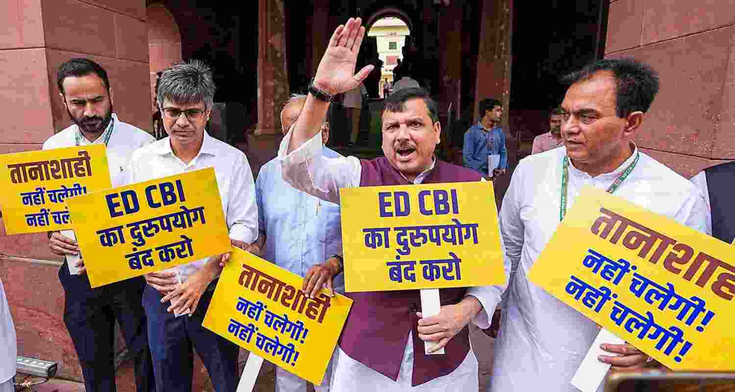  AAP leader Sanjay Singh along with other party leaders protests against the Central Government over the alleged misuse of CBI and Enforcement Directorate (ED) at the Parliament House complex, in New Delhi, Thursday. 