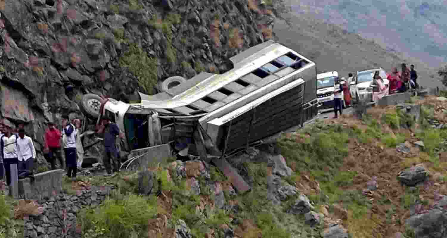 Locals gather after a Himachal Roadways Transport Corporation (HRTC) bus overturned on the Kuddu-Diltari road, in Shimla district, Friday, June 21, 2024. At least four people were killed and three others suffered injuries, according to officials.