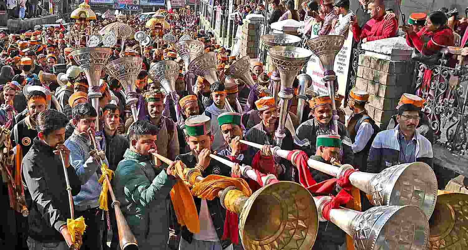 Devotees play musical instruments at a religious procession during the week-long International Shivratri Fair, in Mandi on Friday