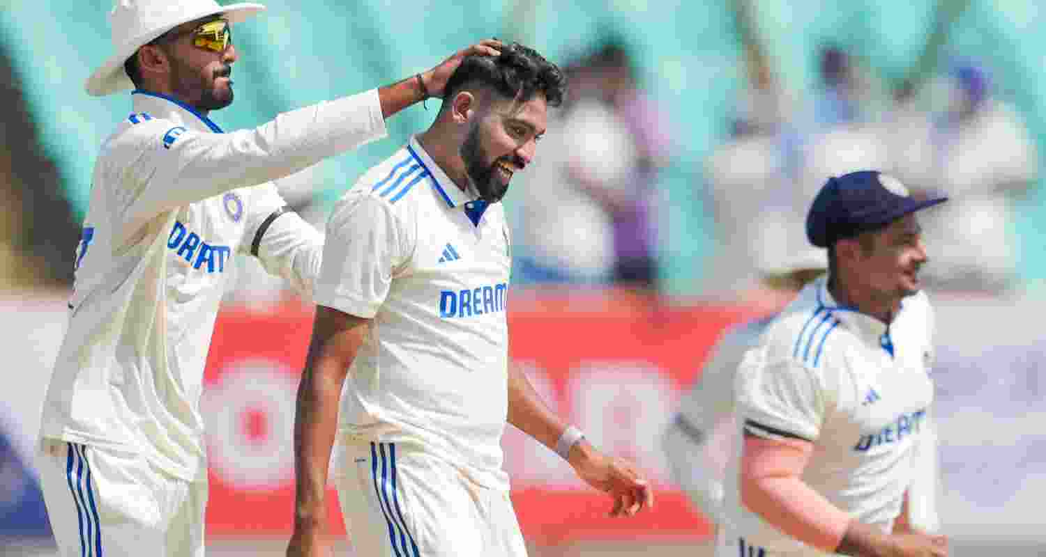 India's Mohammed Siraj with team-mates celebrates the wicket of England's Ben Foakes during the 3rd day of the 3rd cricket test match between India and England, at Niranjan Shah Stadium, in Rajkot on Saturday.