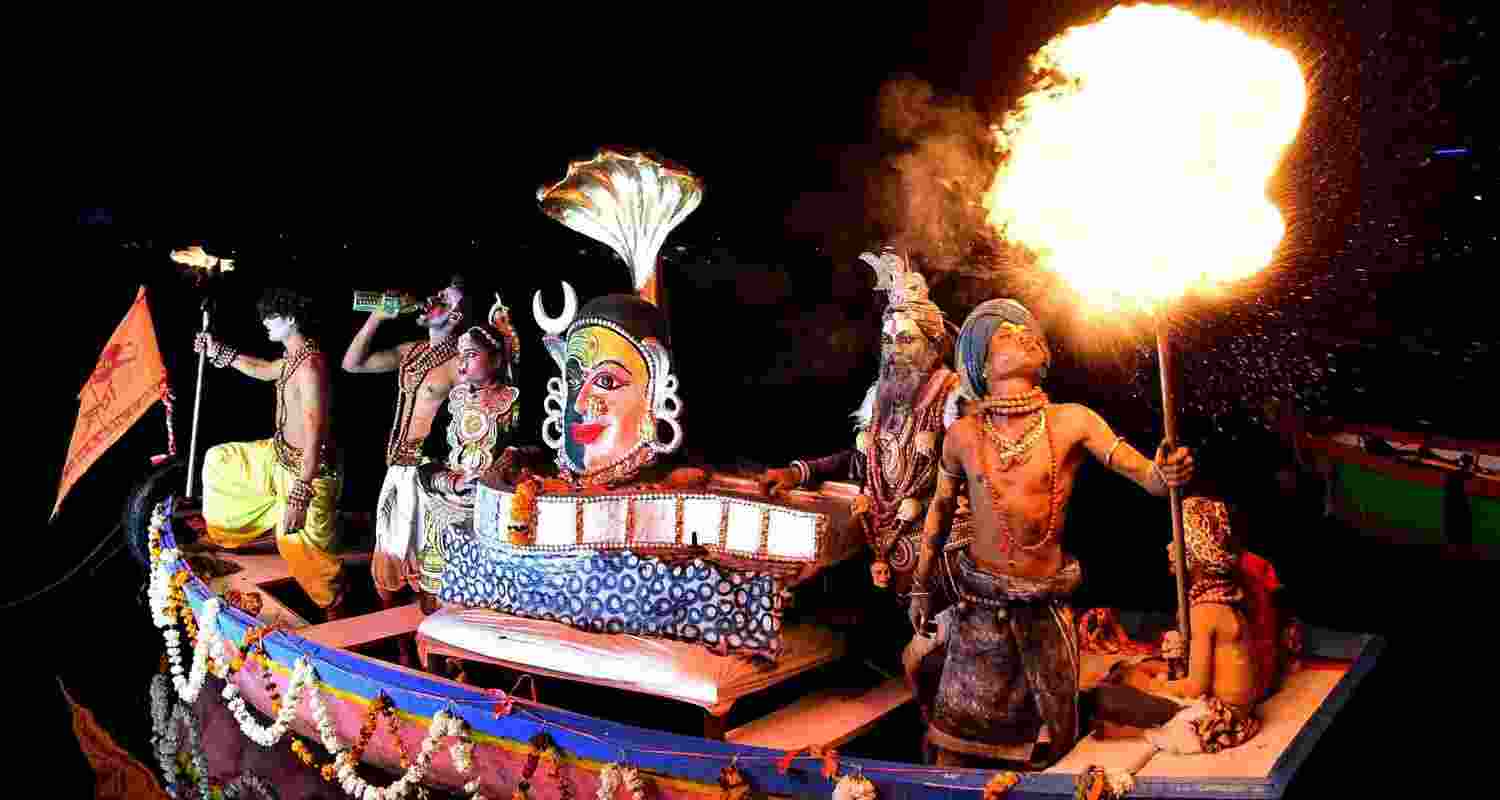 A performer 'breathes fire' during a performance on the occasion of Narmada Jayanti.