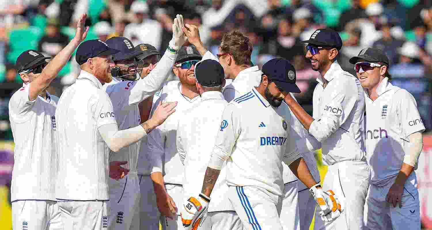 England players celebrate the wicket of Indian batter Ravindra Jadeja during the second day of the fifth Test cricket match between India and England, in Dharamsala, on Friday