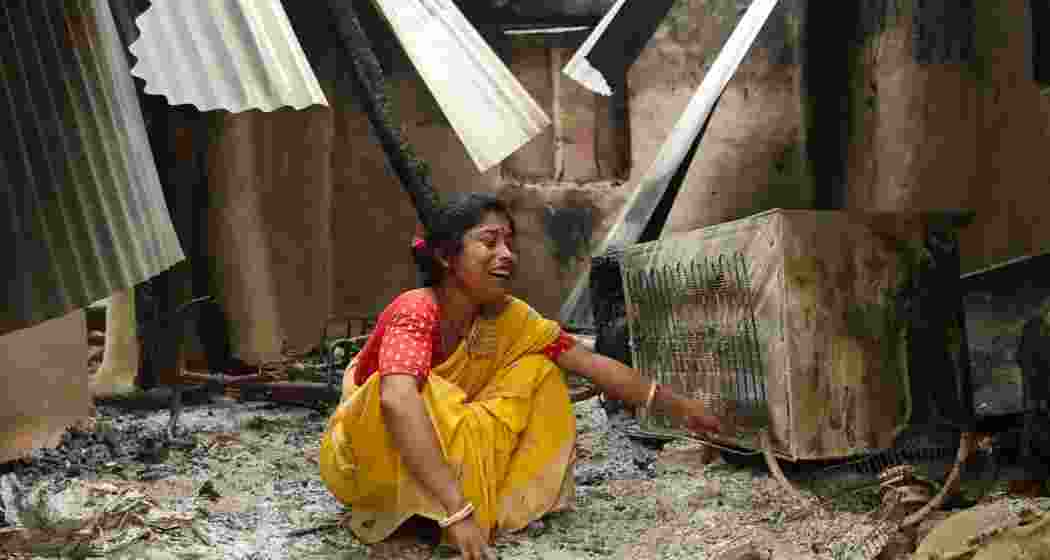 A woman inside her home which was damaged by violence following the death of a tribal youth prior to the panchayat elections.