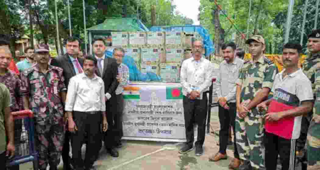 Indian officials hand over GI-tagged Queen pineapples of Tripura, sent by Tripura Chief Minister Manik Saha as a gift to Prime Minister of Bangladesh Sheikh Hasina, to Bangladeshi officials nationals at India-Bangladesh border, in Agartala. 