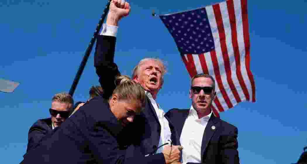 Trump, supported by security personnel, after being grazed by a bullet.