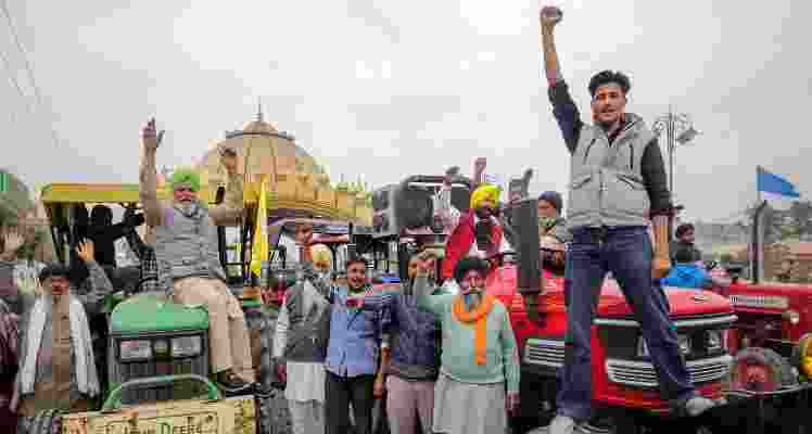 Farmers raise slogans during a tractor rally taken out in support of the farmers' 'Delhi Chalo' protest. 