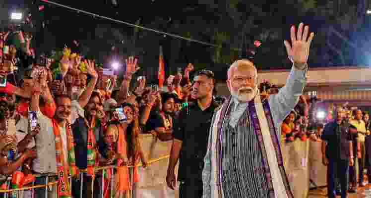 PM Modi waving at the crowd during one of his rallies. 