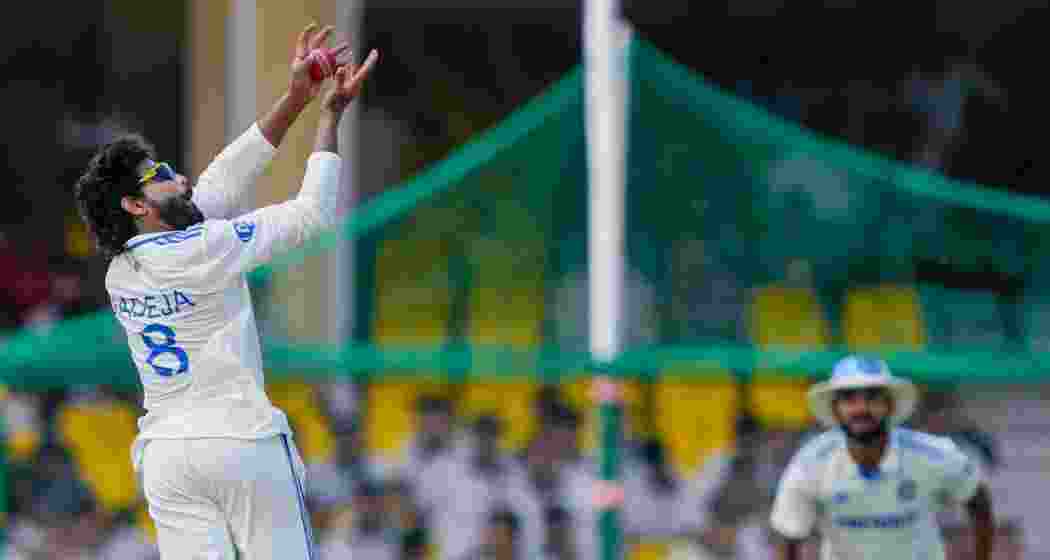 India's Ravindra Jadeja takes the catch of Bangladeshi batter Khaled Ahmed during the fourth day of the 2nd Test cricket match between India and Bangladesh, at the Green Park stadium, Kanpur, Monday, Sept. 30, 2024.