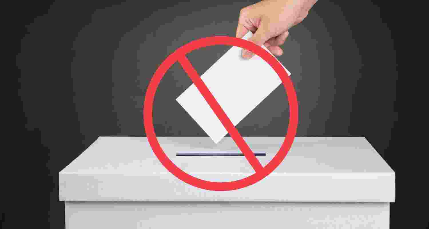 Image of person voting with abstain sign. 