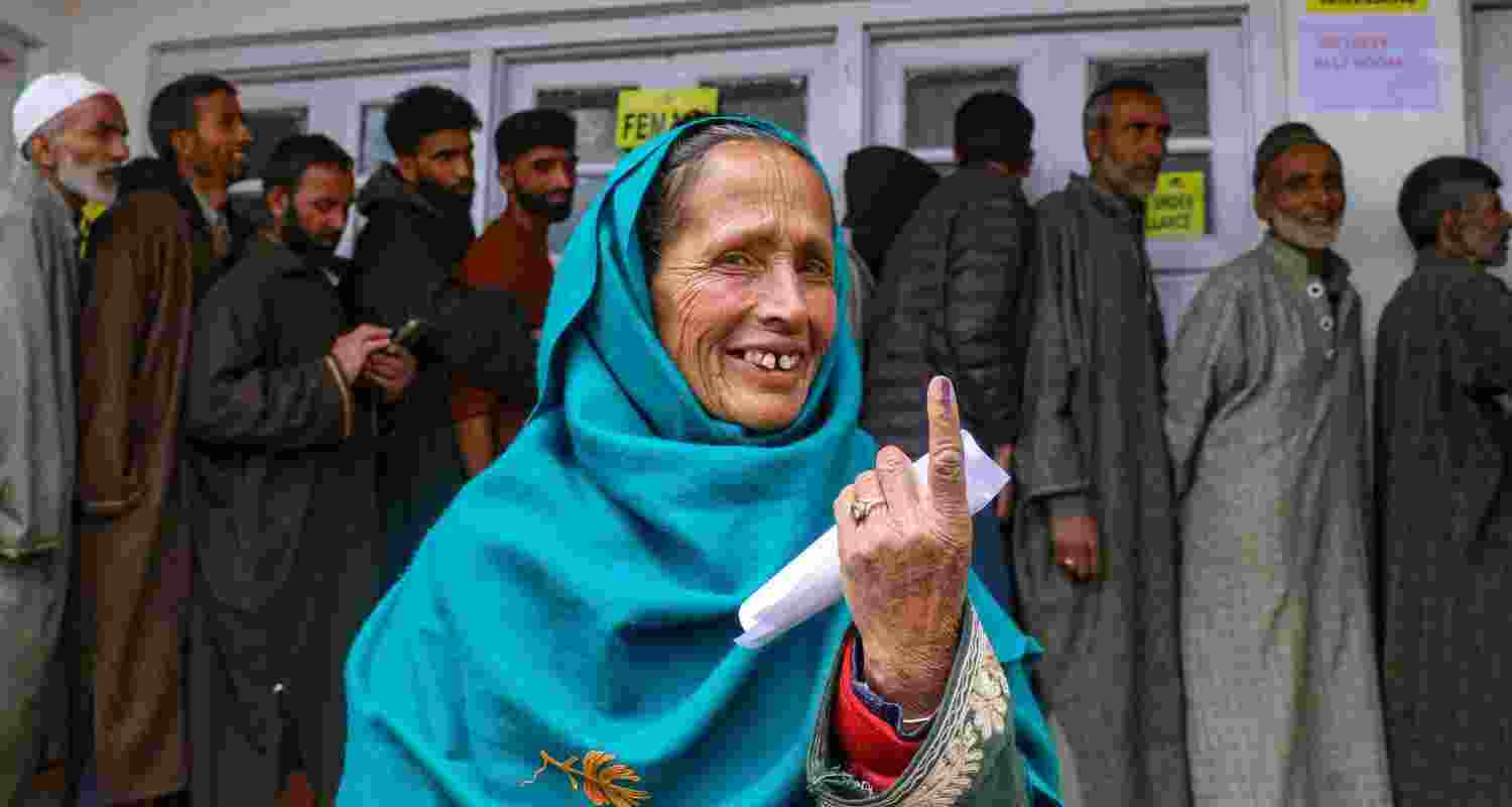 A woman displays her inked finger after casting a vote in Srinagar. The Srinagar voter turnout has led to various politicians voicing varying opinions.