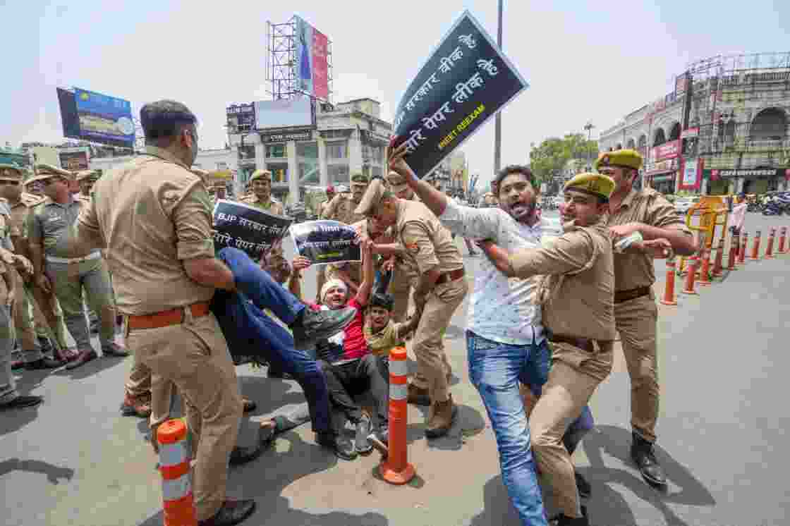 Police personnel detain Samajwadi Party members during a protest against the Central Government over the cancellation of UGC-NET 2024 exam, in Lucknow, Thursday.