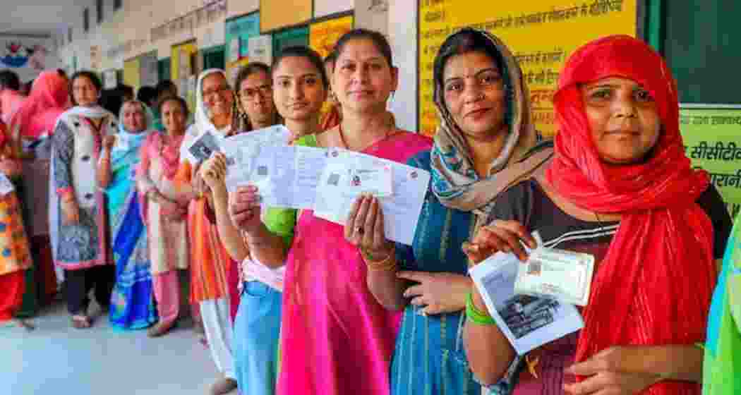 Image shows women voters waiting to cast their votes for the Lok Sabha elections in Bulandshahr.