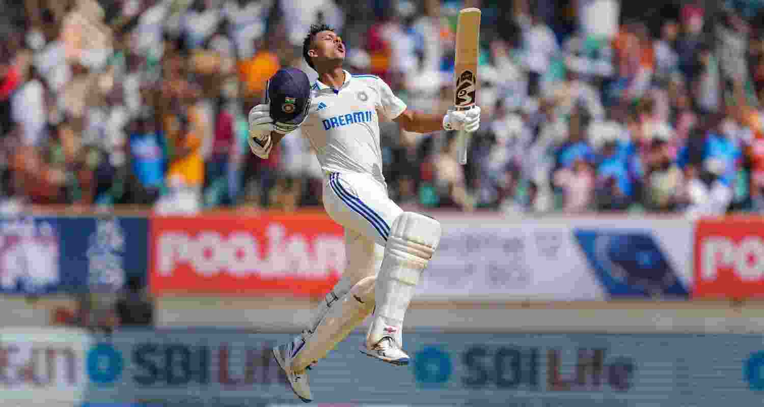 Yashasvi Jaiswal leaps in the air and pumps up his bat to celebrate his double century.