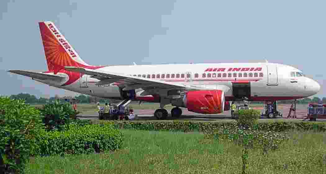 Security personnel inspect an Air India aircraft at IGI Airport, Delhi