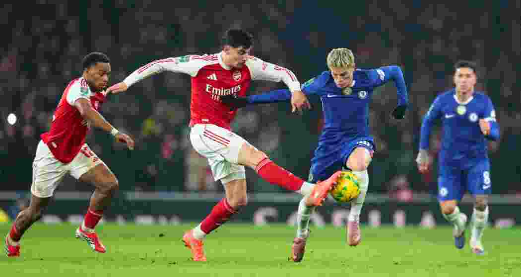 Arsenal's Kai Havertz (center left) and Chelsea's Alejandro Garnacho challenge for the ball during the English League Cup semifinal second leg soccer match between Arsenal and Chelsea in London. 