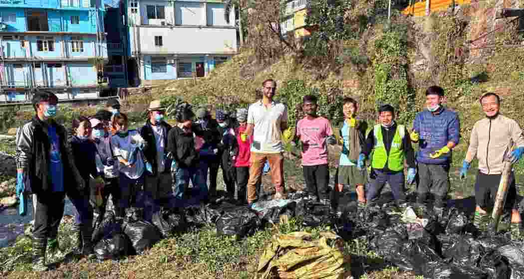 Volunteers segregate plastics and debris collected from Yagamso River during a cleanliness drive in Itanagar on Saturday.