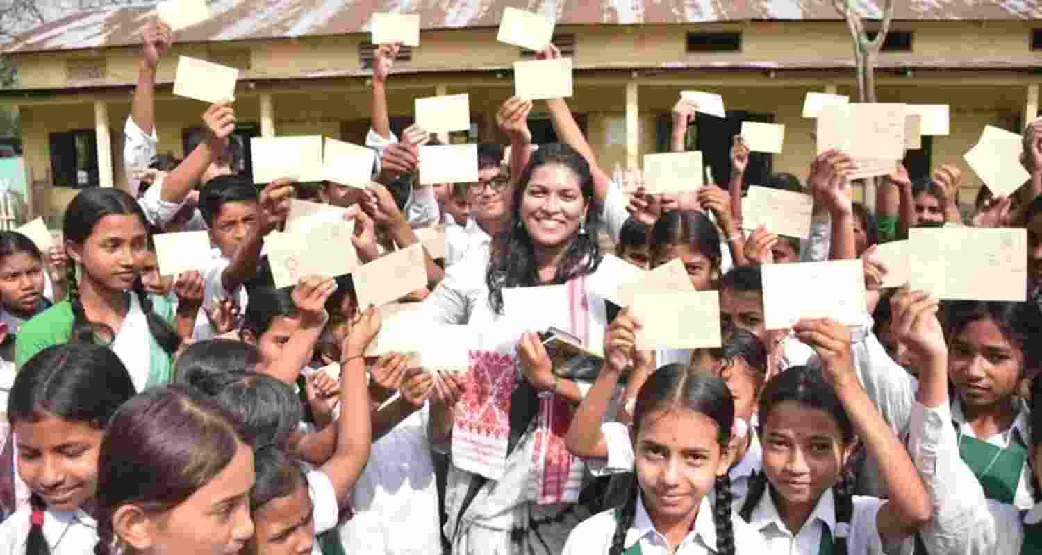Students in Assam showcase postcards addressed to their parents, urging them to vote.