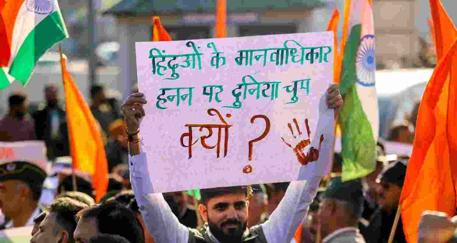 People take part in a protest march against the atrocities on religious minorities in Bangladesh, in Jammu.